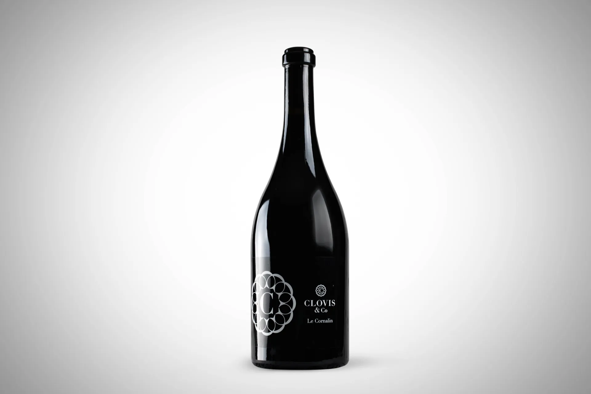 Studio — Bouteille de vin rouge sur fond dégradé neutre, étiquette gravée — packshot studio pour Clovis & Co